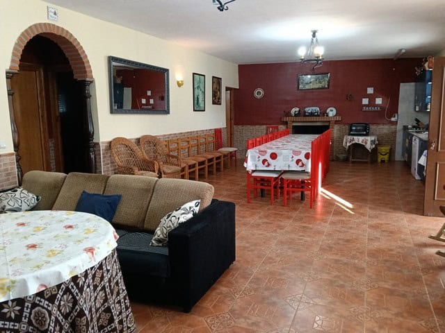 Spacious interior of a rural property in Benamaurel, Granada, featuring a cozy living area and tradi.