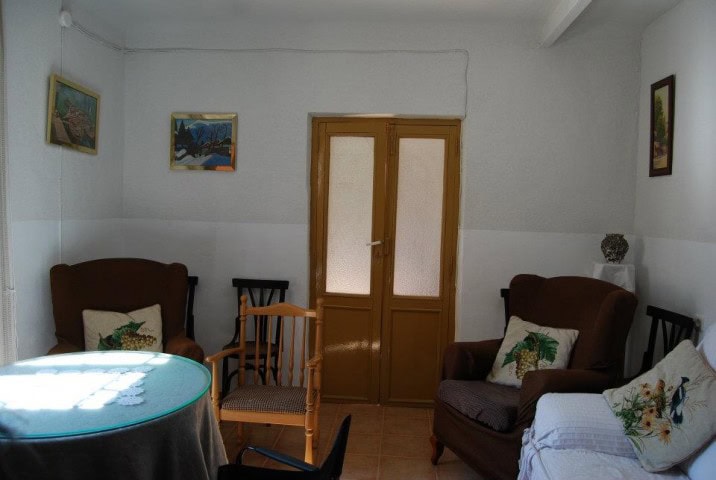 Charming interior of a village property in Cuevas del Campo, Granada, featuring cozy seating and tra.