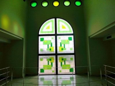 Elegant stained glass window in a country estate in Pozo Alcon, Jaen, with vibrant green and white g.