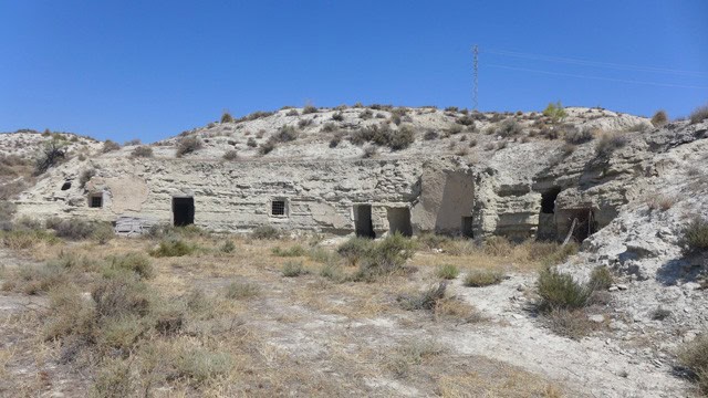 Ruins of an old structure in Benamaurel, Granada under a clear blue sky.