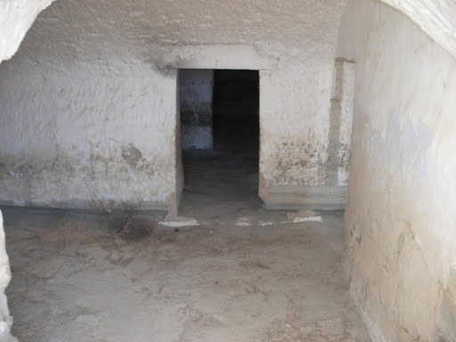 Ruin in Benamaurel, Granada with ancient stone walls and an arched doorway.