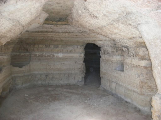 Ancient cave entrance carved into rock in Benamaurel, Granada, showcasing historical geological form.