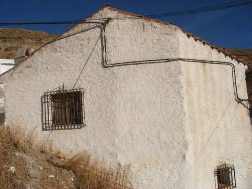 Village property in Gorafe with whitewashed walls and traditional barred windows.