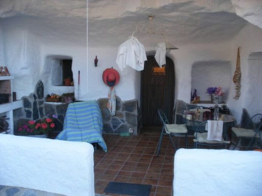 Traditional cave house interior with rustic decor in Cortes de Baza, Granada.