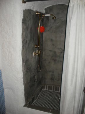 Cave house shower with rustic fixtures in Cortes de Baza, Granada. Unique underground living space w.