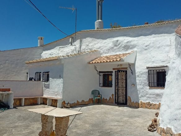 Cave house in Hinojares, Jaen, featuring whitewashed walls and rustic charm.