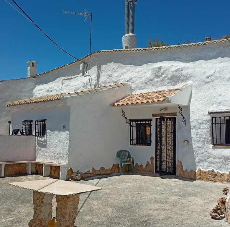 Cave house in Hinojares, Jaen, featuring whitewashed walls and rustic charm.