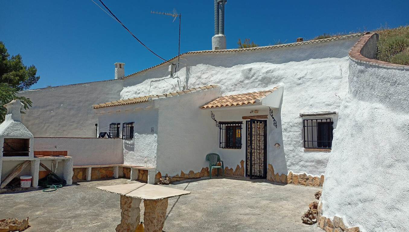 Cave house in Hinojares, Jaen, featuring whitewashed walls and rustic charm.