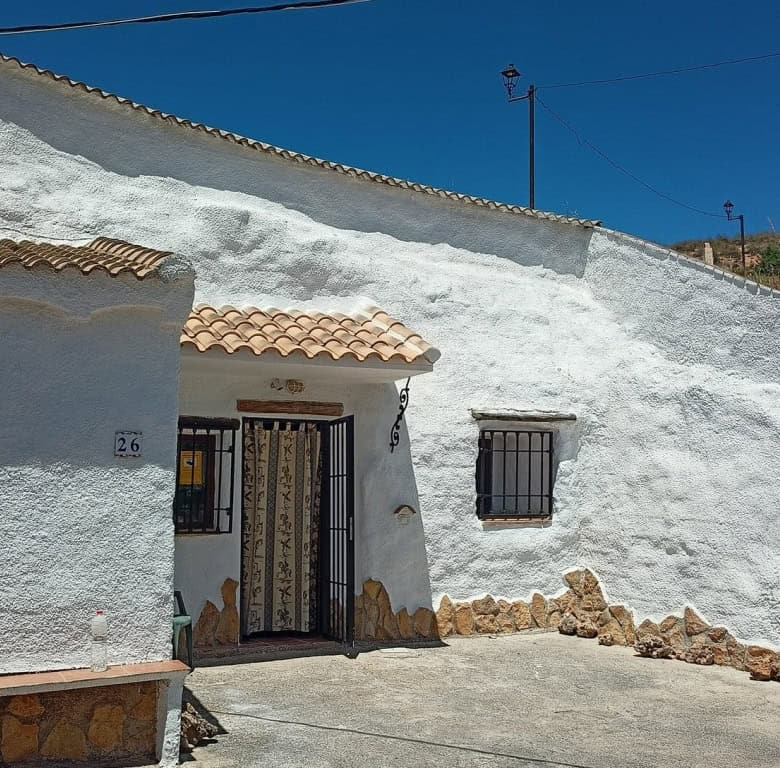 Cave house in Hinojares, Jaen, with whitewashed walls and rustic charm.