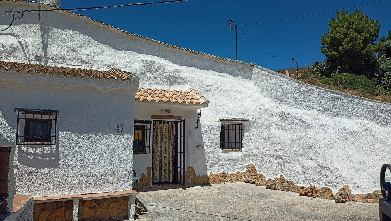 Cave house in Hinojares, Jaen, with whitewashed walls and rustic charm.