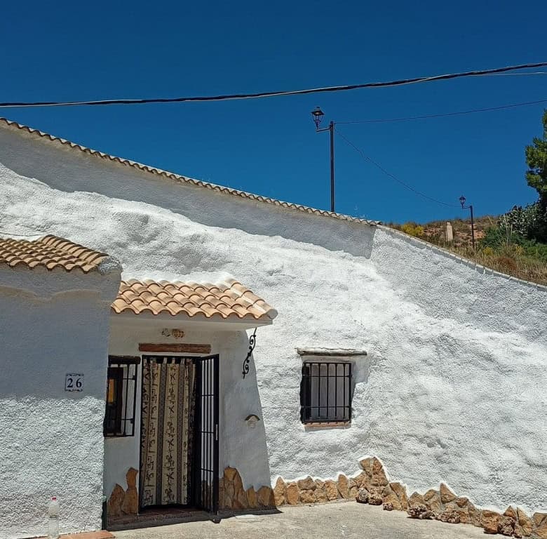 Charming cave house in Hinojares, Jaen, featuring traditional whitewashed walls and rustic charm.