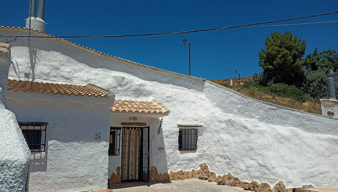 Charming cave house in Hinojares, Jaen, featuring traditional whitewashed walls and rustic charm.