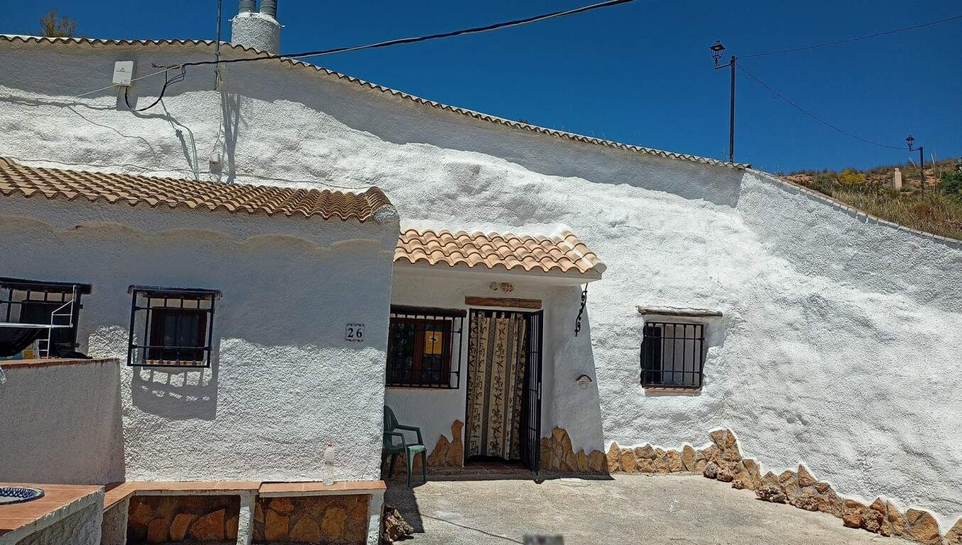 Cave house in Hinojares, Jaen with whitewashed walls and rustic charm.