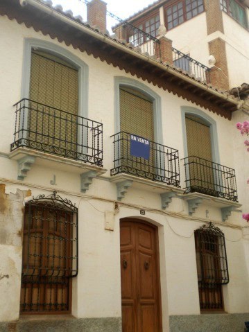 Charming village property in Guadix, Granada with traditional balconies and wooden door. Perfect for.