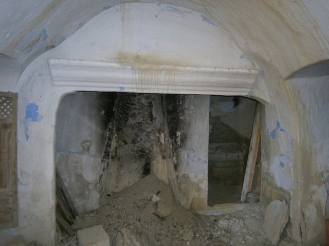 Interior of rustic rural property with stone fireplace and arched ceiling in Venta del Peral, Granad.