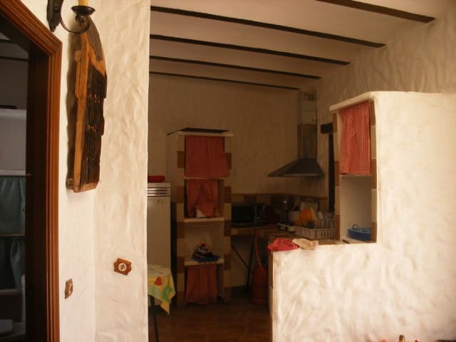 Cave house interior in Cuevas del Campo, Granada, showcasing rustic charm and traditional architectu.