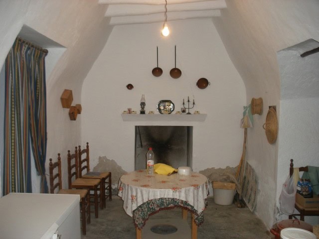 Charming cave house interior in Castillejar, Granada, featuring rustic decor and traditional furnish.