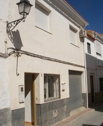 Commercial property for sale in Castillejar, Granada, featuring a white facade and street access.