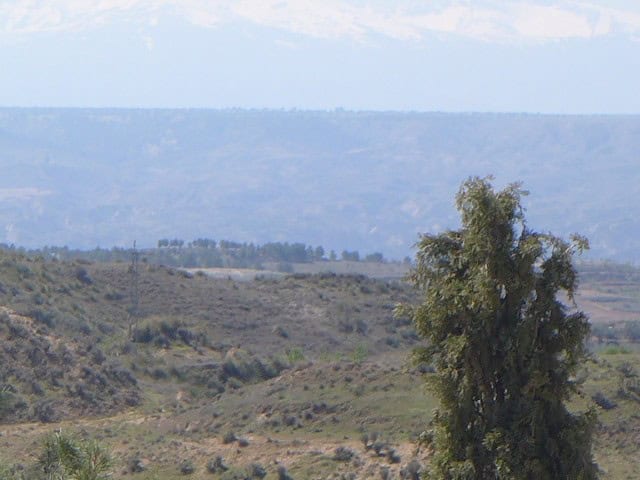 Cave house located in Cuevas del Campo, Granada, set in a scenic rural landscape with rolling hills.
