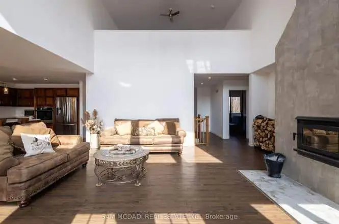 Spacious interior of a 3-bedroom estate in Belmont, Ontario, featuring a cozy living room with a fir.