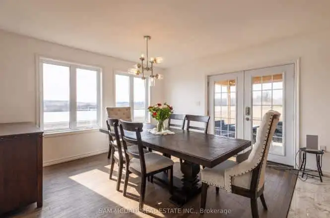Spacious dining room with large windows and lake views in Belmont, Ontario. Perfect family home for.