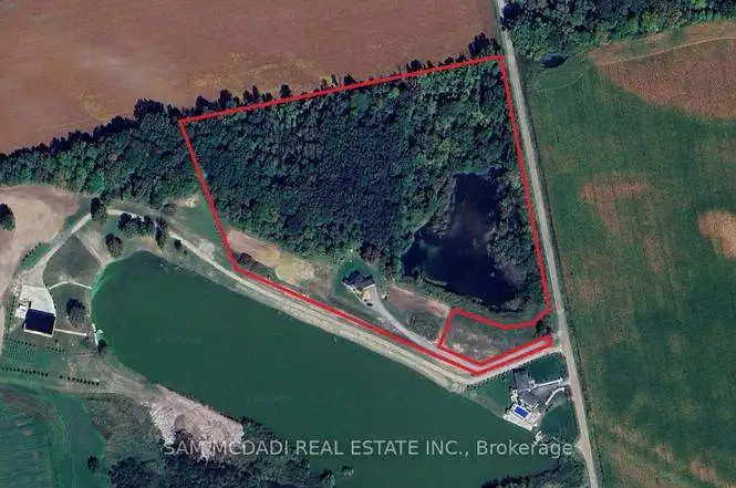 Spacious estate with a pond, surrounded by lush greenery and trees in Belmont, Ontario.