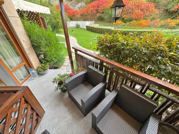 Balcony overlooking lush garden at Garden of Eden, Sveti Vlas, with outdoor seating.