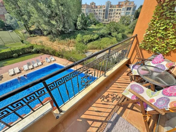 Balcony view of furnished studio at SPA Hotel Sunny Beach with pool and garden.