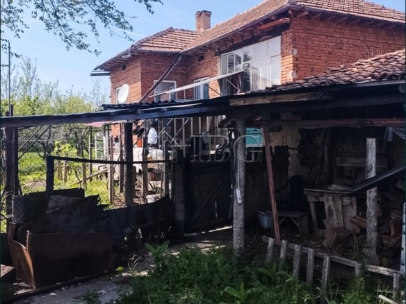 Two-storey brick house with large garden and outdoor storage area. Prime edge-of-village location of.