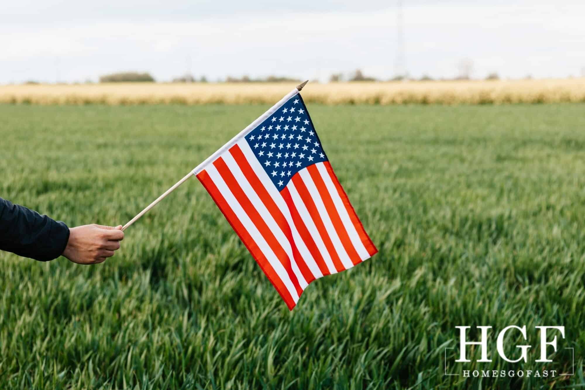 American flag waving in a lush green field, symbolizing Americans relocating to Europe.