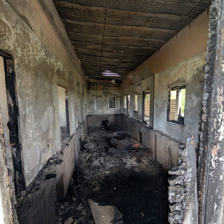 Interior of a partially burned or damaged building in Fortlands, Basseterre, Saint Kitts, showing ch.