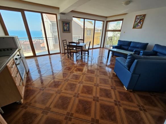 Spacious living room with panoramic sea views, modern furniture, and large windows in Rusalka Distri.
