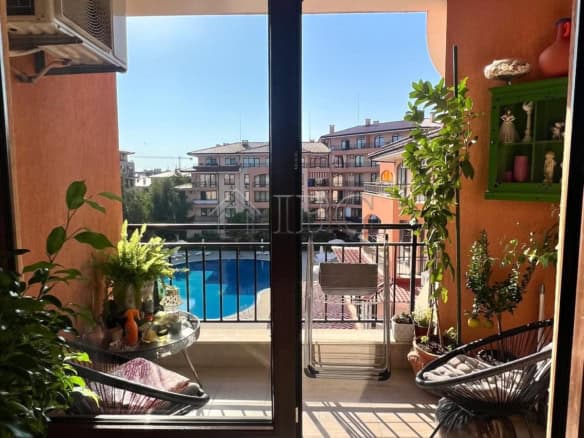 Apartment with pool and partial sea view in Sveti Vlas. Bright balcony with outdoor seating and lush.