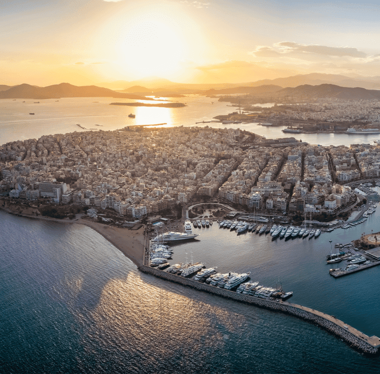 Aerial view of Skyway in Athens, Greece during sunset with city and harbor scenery.