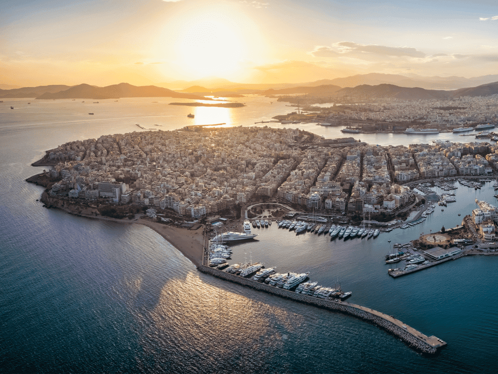 Aerial view of Skyway in Athens, Greece during sunset with city and harbor scenery.