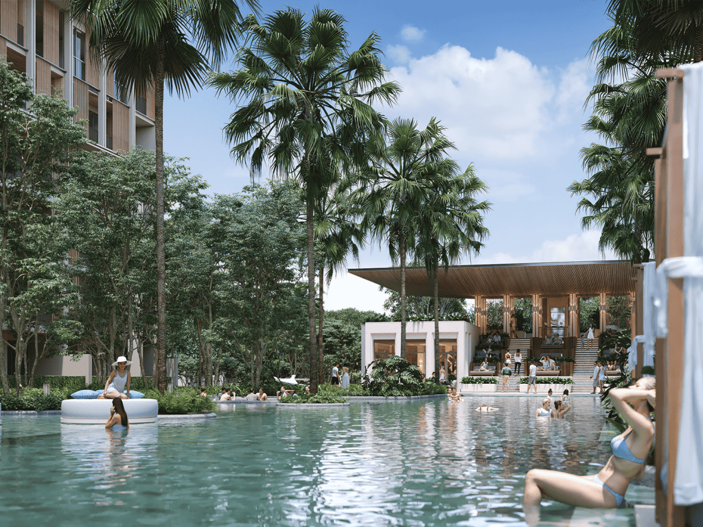 Poolside view at Sudara Phuket resort with palm trees and relaxing guests.