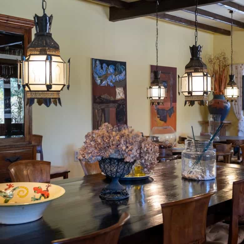 Charming dining area featuring wooden table, vintage pendant lights, and decorative accents.