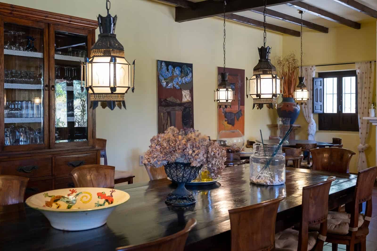 Charming dining area featuring wooden table, vintage pendant lights, and decorative accents.