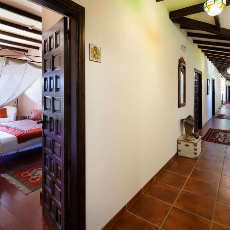 Spacious bedroom featuring a four-poster bed and elegant drapery, perfect for a cozy stay in a histo.