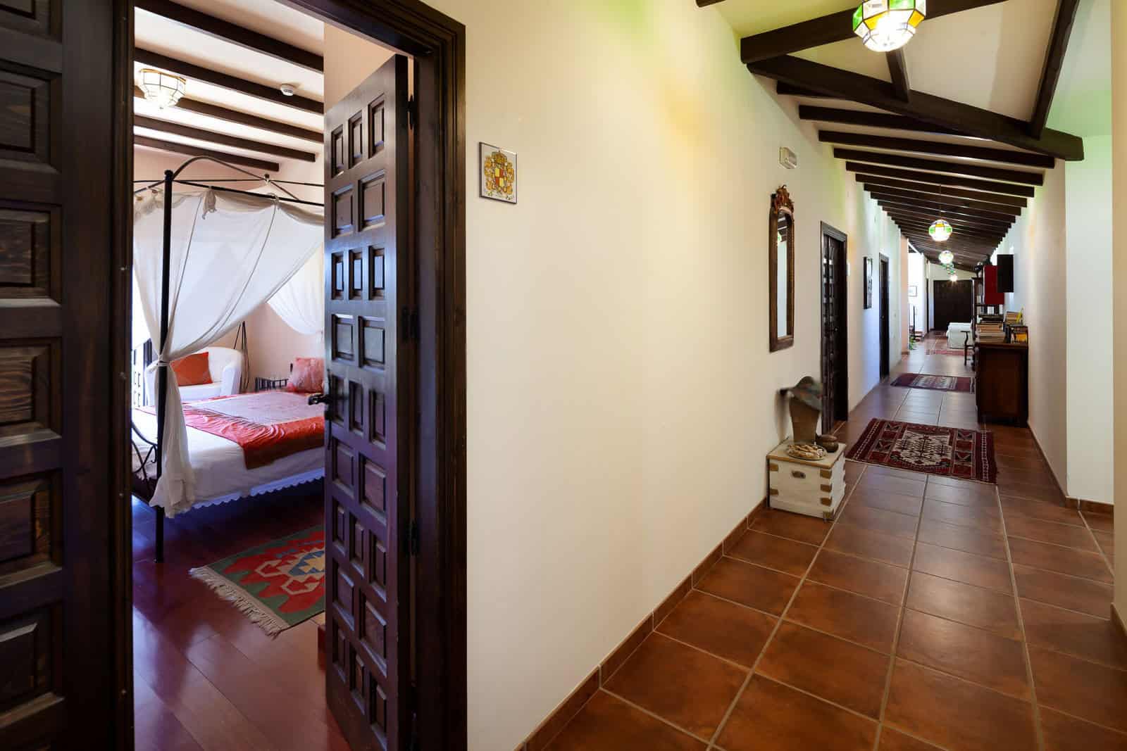 Spacious bedroom featuring a four-poster bed and elegant drapery, perfect for a cozy stay in a histo.