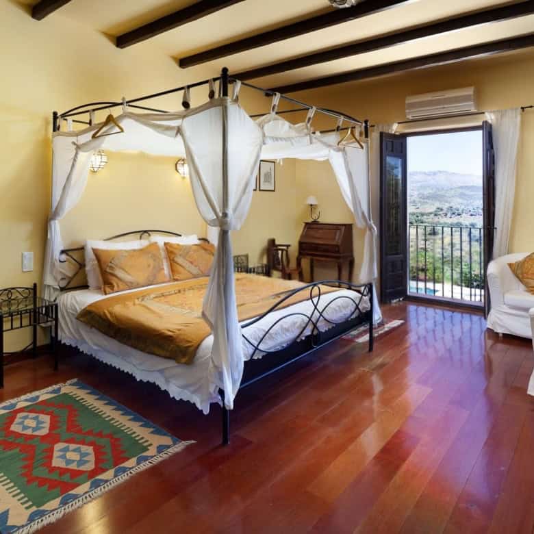 Elegant bedroom with balcony view in a charming home.