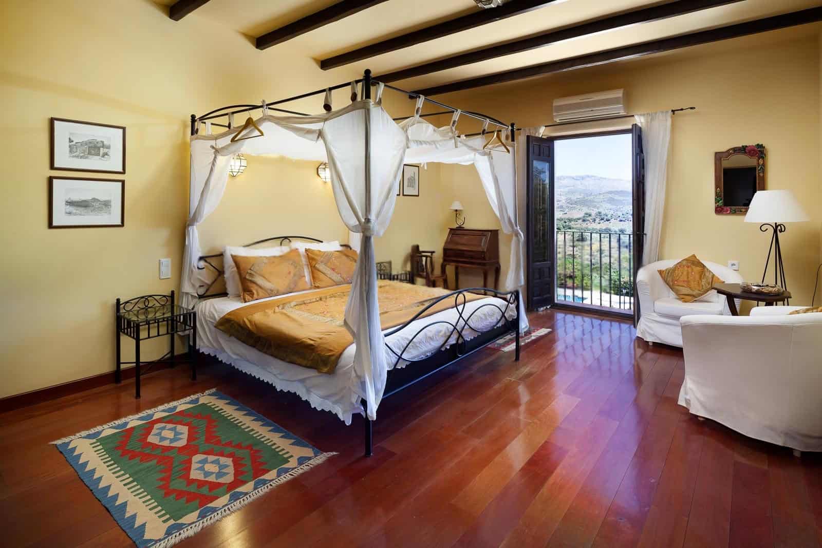 Elegant bedroom with balcony view in a charming home.