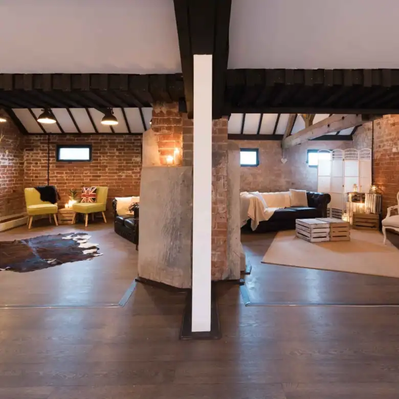 Stylish loft interior featuring brick walls, modern and vintage furniture, cozy lighting, and open s.
