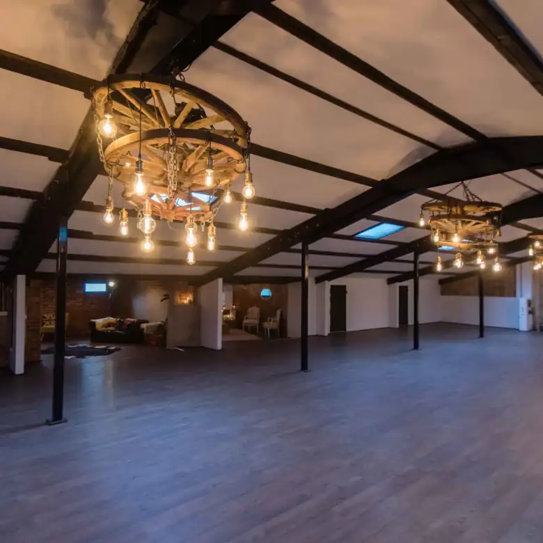 Bright, open interior with rustic lighting fixtures and high ceilings.