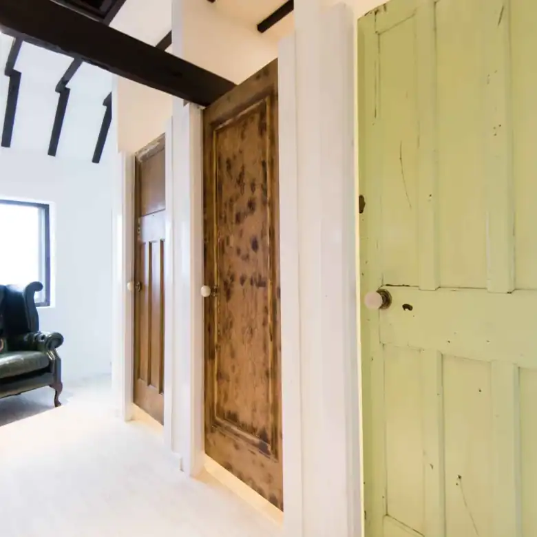 Interior view featuring vintage wooden doors and a cozy sitting area.