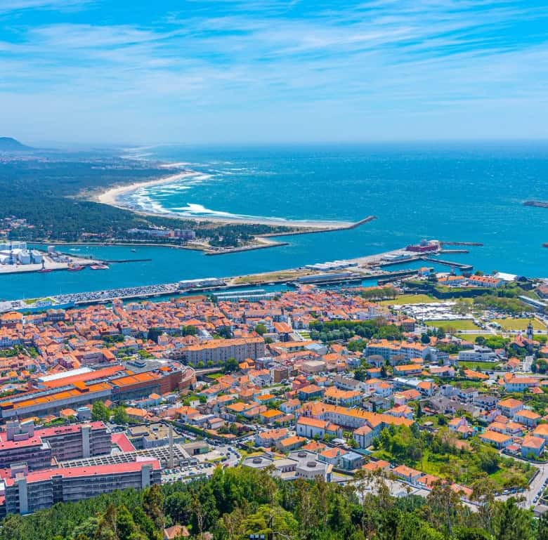 Aerial view of Viana do Castelo showing the coastline, port, and cityscape in Portugal.