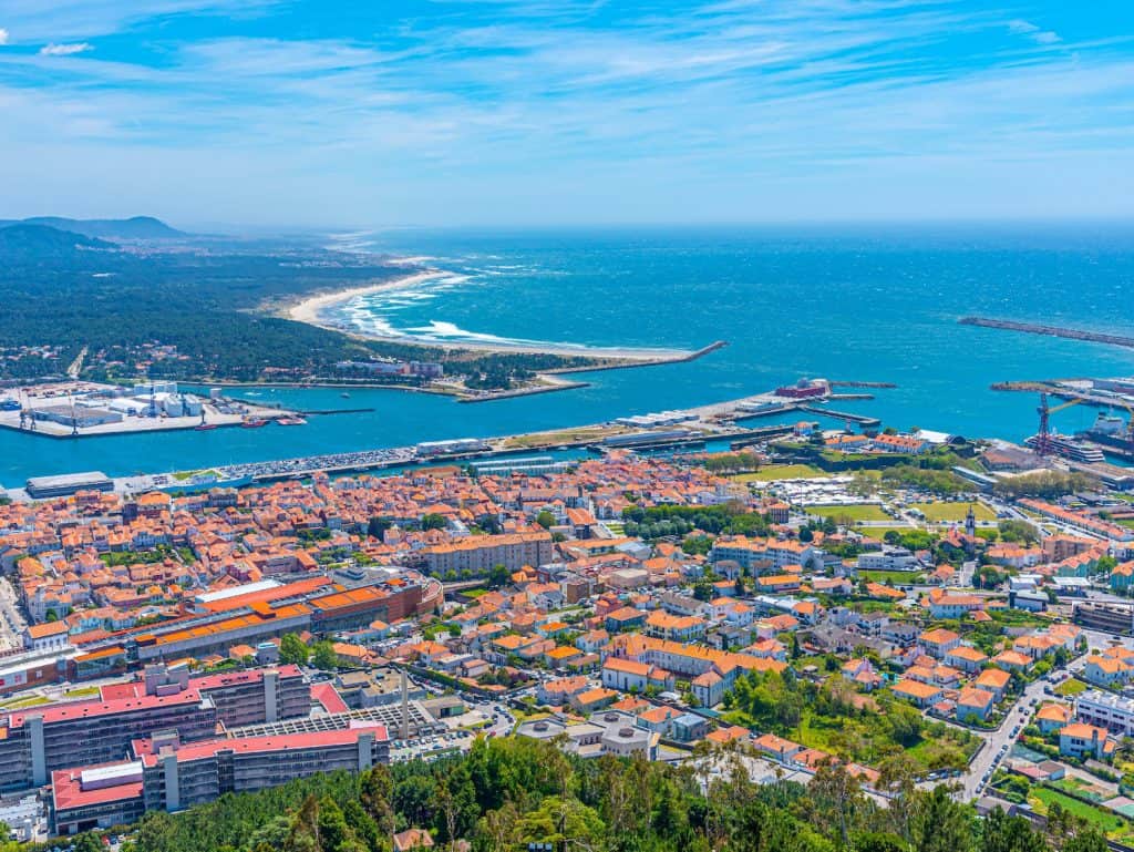 Aerial view of Viana do Castelo showing the coastline, port, and cityscape in Portugal.