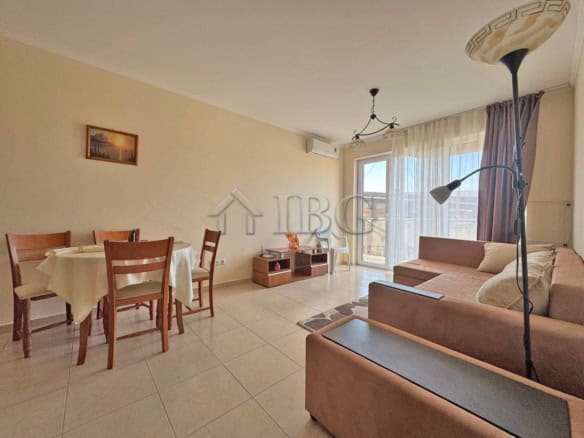 Bright living room with sofa, dining area, and balcony in Sunny Beach complex "Vip Image".