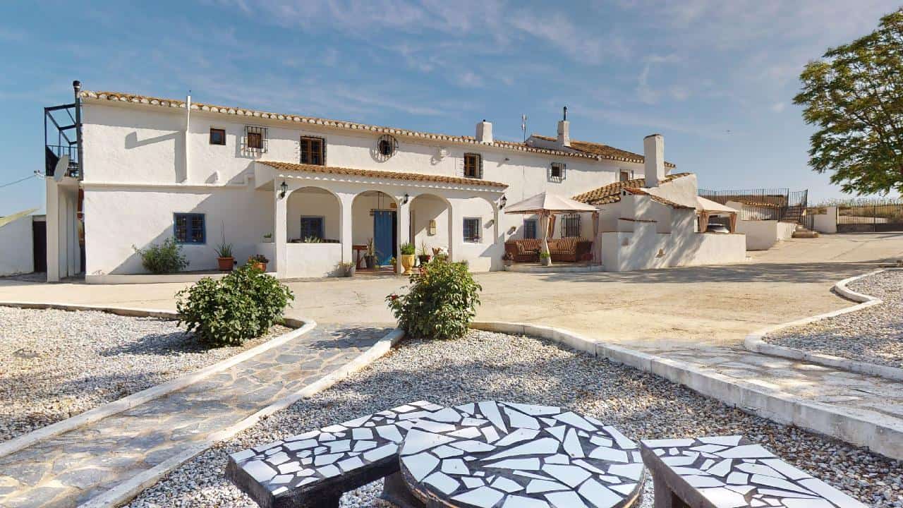 Boutique hotel for sale in Caniles, Granada, featuring traditional Spanish architecture and scenic s.