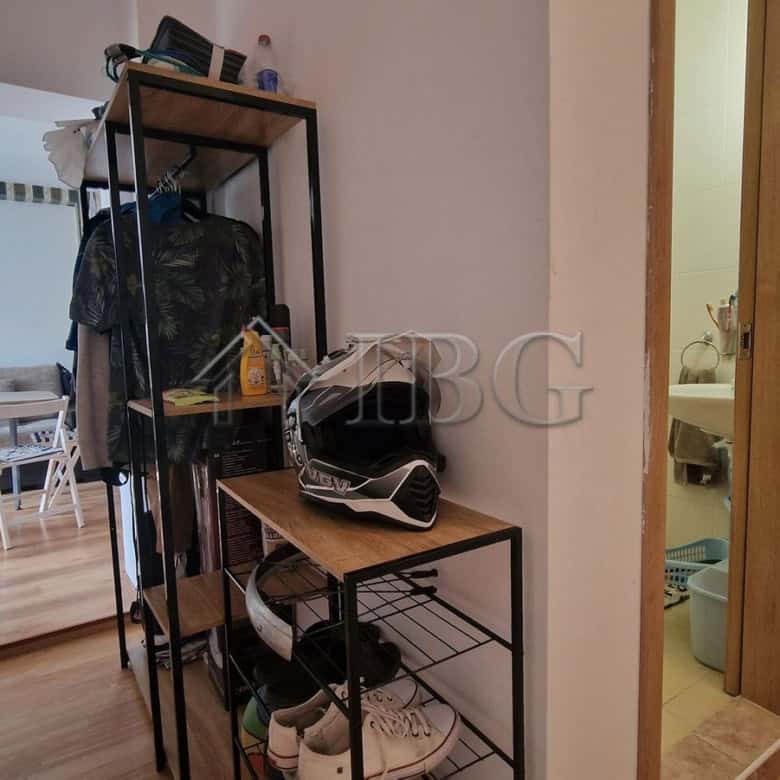 Interior of a 1-bedroom apartment with pool view, showing hallway and living area.